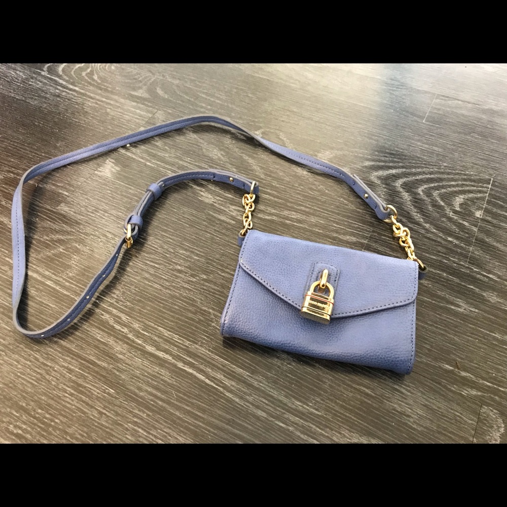 A blue and gold tommy holdover crossbody bag